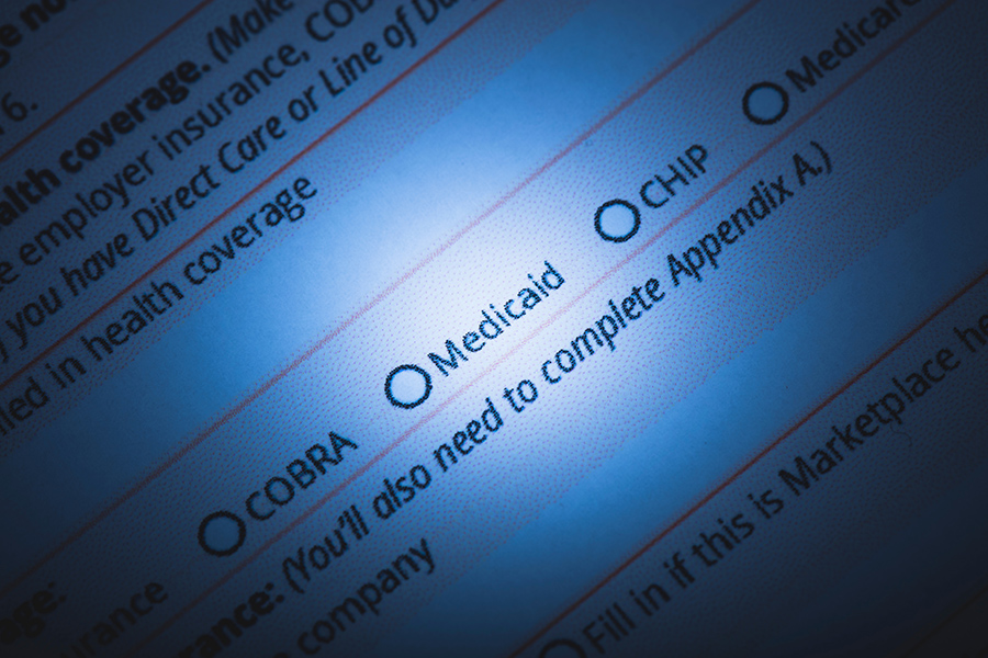 image of health insurance form, spotlight on Medicaid radial button. One million struck from Medicaid rolls in 2023.