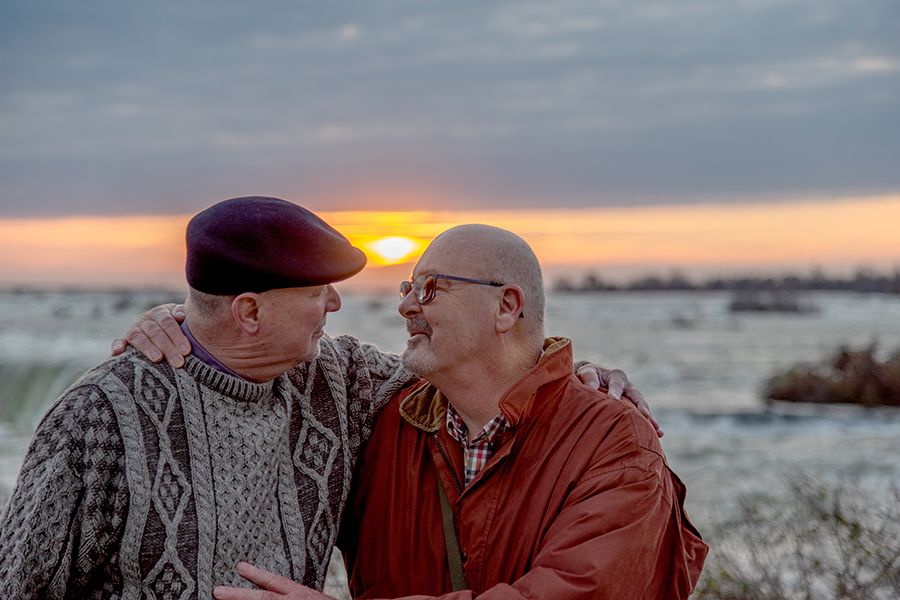 LBGTQ+ caregivers. Senior couple looking lovingly into each others' eyes at sunset.
