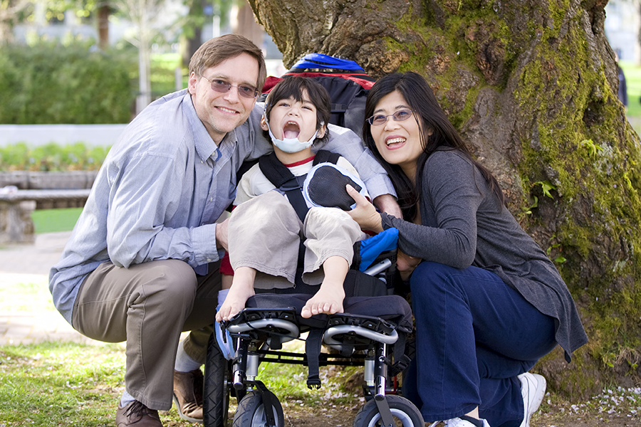Disabled child surrounded by parents